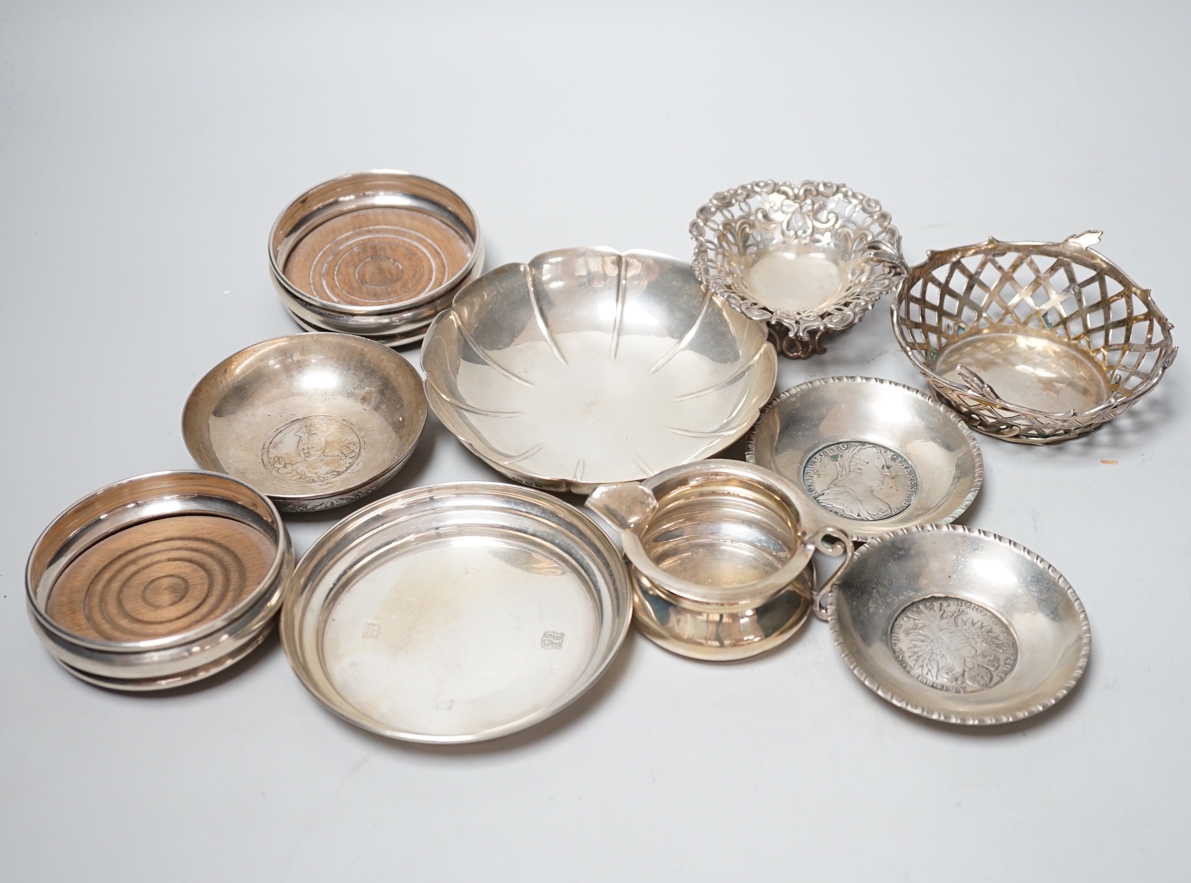 A modern pair of small silver mounted coasters, diameter 79mm, seven other silver or white metal dishes including Dutch and a small silver cream jug.